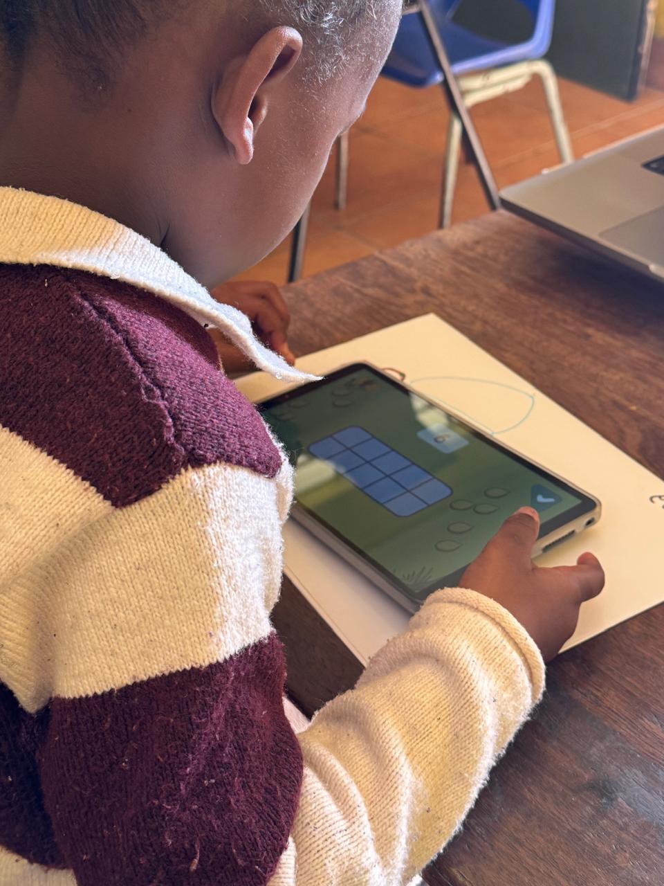 Child using Nanisca on a tablet in a classroom